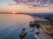 Aerial sunset  view of the beautiful Praia dos Tres Irmaos Tree Brothers beach in Alvor, famous tourist destination in Algarve