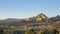 Aerial sunset view of the Capitol Butte mountain and Sedona`s cityscape