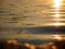 Aerial sunset view of the ocean, with the reflection of the sun on the waves. The reflection of the golden sun in the waves of the