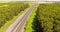 Aerial survey of the truck. Tilt-covered dump truck carrying coal along the country road. Truck moving on dirt country