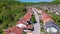 AERIAL: Terraced houses sprawl across the vast lush green expanse in Slovenia.