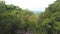 Aerial: Three Carefree Hiker Tourists Sitting at Waterfall and Scattering the Hands by the Sides. HD Slowmotion