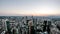 Aerial time lapse of the Frankfurt / Main skyline and construction site of a skyscraper during sunset on a hot summer