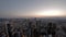 Aerial time lapse of the Frankfurt / Main skyline and construction site of a skyscraper during sunset on a hot summer