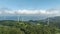 Aerial timelapse: Turbines spin as clouds move over coastal wind farm