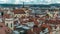 Aerial timelapse view of the traditional red roofs of the city of Prague, Czech Republic with the church of St. Jilji