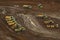 Aerial of tip trucks waiting to be filled with dirt during pipeline construction in the Southern highlands Papua New Guinea.