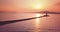 Aerial of Tokarevsky lighthouse at sunrise and lonely person walking from it