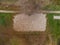 Aerial top down drone shot of deserted beach volleyball playing field in local recreation area in autumn with fallen leaves