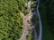 Aerial top down drone view, forest road near small flooded mountain river