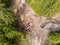 Aerial top down drone view, small flooded mountain creek flowing