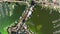 Aerial top down of river banks in fisherman village with green algae in water