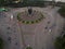 Aerial top down of traffic in Bekasi roundabout during sunny day. Cars passing road. Bekasi. Indonesia. May, 6 2021