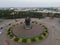 Aerial top down of traffic in Bekasi roundabout during sunny day. Cars passing road. Bekasi. Indonesia. May, 6 2021