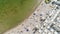 Aerial top down view on a city beach. Crowd of people resting and swimming on beautiful beach near the ocean,