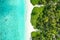 Aerial top down view of an exotic island with crystal water and sandy beach