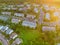 Aerial top down view flying over appartments in small town showing neighborhood early sunrise