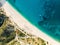 Aerial top down view of Myrtos beach, the most famous and beautiful beach of Kefalonia, a large coast with turqoise water and