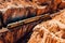 An aerial top-down view of a train winding through a breathtaking canyon, with steep cliffs and rugged terrain