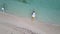 Aerial top down view of white sand beach with a traditional philippine boats beached on it