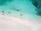 Aerial top down view of white sand beach with a traditional philippine boats beached on it