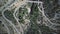 Aerial top-down view of a windy hairpinned car road in mountains in Spain