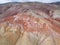 Aerial top down view on Zhangye Rainbow mountains displaying colorful pattern