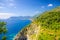 Aerial top panoramic view of green hills, rocks, cliffs and Gulf of Genoa, Ligurian Sea, coastline of Riviera di Levante, National