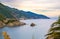 Aerial top panoramic view of green hills, rocks, cliffs and Gulf of Genoa at sunset dusk, Ligurian Sea, coastline of Riviera di Le