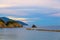 Aerial top panoramic view of green hills, rocks, cliffs and Gulf of Genoa at sunset dusk, Ligurian Sea, coastline of Riviera di Le