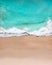 Aerial top shot of a beach with nice sand, blue turquoise water and tropical vibe