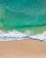 Aerial top shot of a beach with nice sand, blue turquoise water and tropical vibe