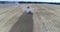 Aerial top shot of thre modern green harvesters harvesting on the wheat field