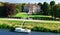 Aerial top view of ancient villa Giovanelli, garden and houseboat barge on canal Brenta from above, family vacation cruise on boat