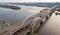 Aerial top view of automobile and railroad Darnitsky bridge across Dnieper river from above, Kiev Kyiv city sunset skyline