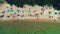 Aerial top view on the beach. Umbrellas, sand, people and sea waves