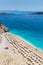 Aerial top view on the beach. Umbrellas, sand and sea waves