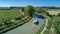 Aerial top view of boat in Canal du Midi from above, family travel by barge and vacation in France