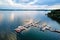 Aerial top view of boats near wooden pier at lake