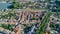 Aerial top view of Castelnaudary residential area houses roofs, streets and canal with boats from above, old medieval town