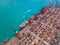 Aerial top view of container cargo ship in the export and import business and logistics international goods in urban city.