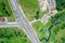 Aerial top view of crossroads, roads and parking lot with trucks in suburb area