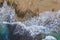 Aerial top view of Cyprus sandy beach with seaweed and sea water with foam, beautiful nature mediterranean background