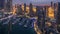 Aerial top view of Dubai Marina night to day timelapse. Modern towers and traffic on the road