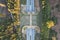 Aerial top view of an ecoduct highway with traffic surrounded by green forests