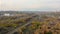 Aerial top view of empty single-way railway at autumn in suburb.