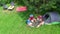 Aerial top view of family in campsite from above, parents and kids relax and have fun in park, tent and camping equipment