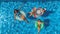 Aerial top view of family in swimming pool from above, happy mother and kids swim on inflatable ring donuts and have fun in water