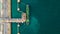 Aerial top view of green oil tanker cargo vessel under cargo ope