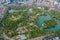 Aerial top view of green trees in Lumpini park garden and reflection. Green eco area in smart urban city at noon, Bangkok,